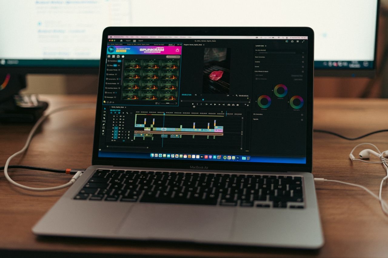 team-03 MacBook Air setup with video editing software open, showcasing a typical workspace environment.